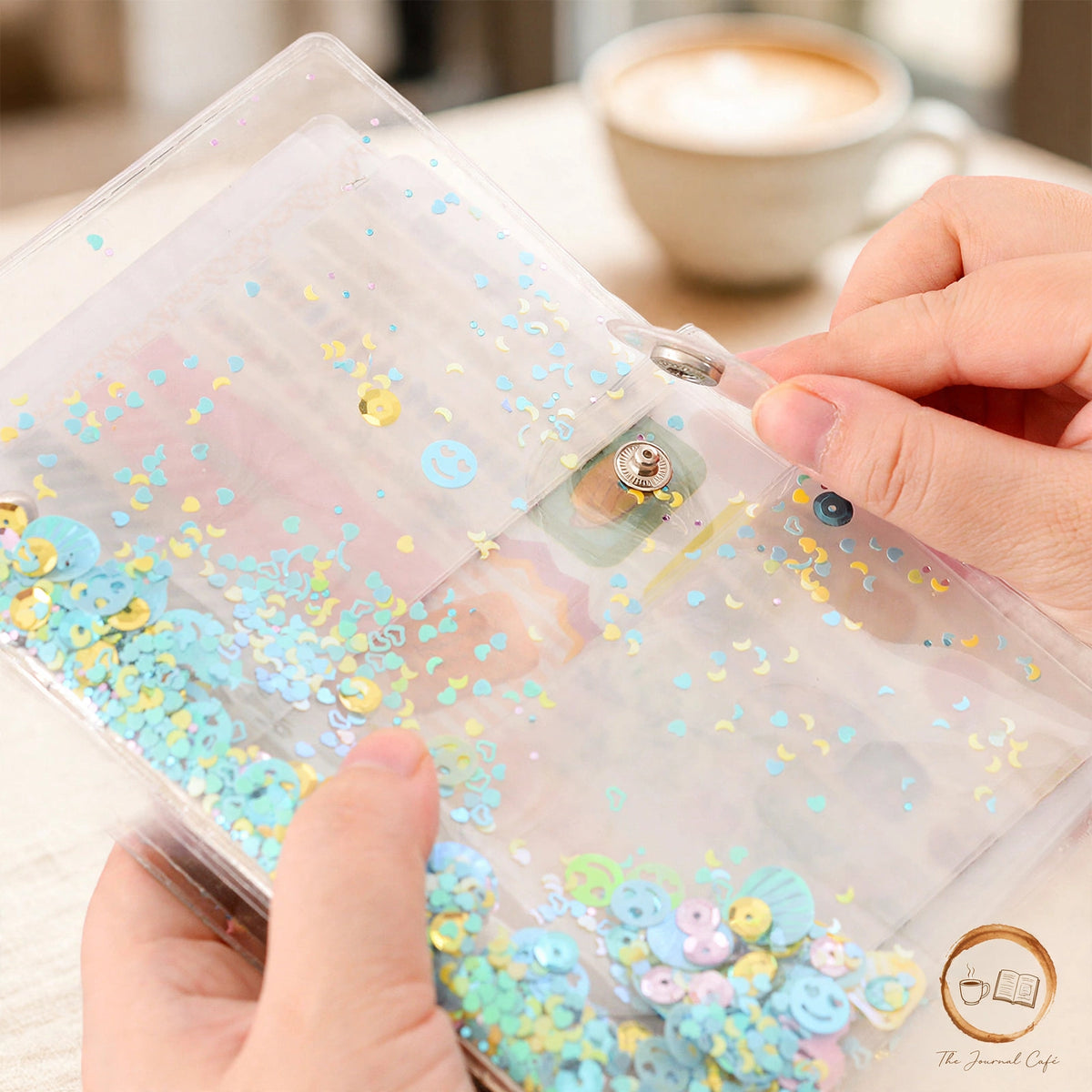 A5 sticker storage book — product photo 3 styled on a cream café table, The Journal Café