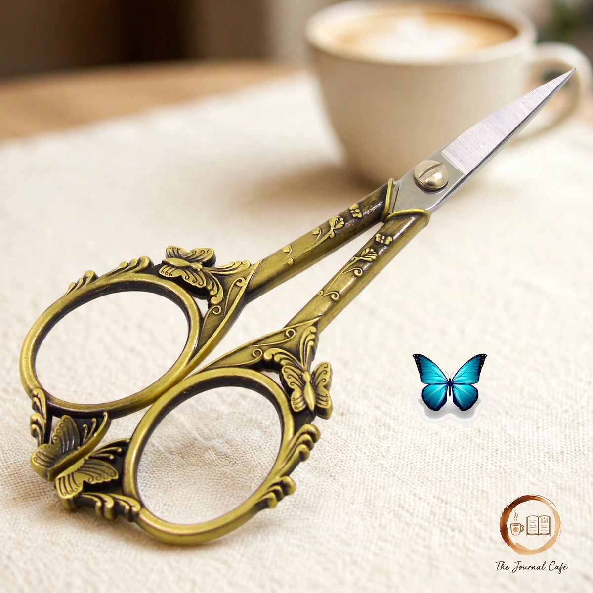 Butterfly cut retro scissors styled on a cream café table, The Journal Café