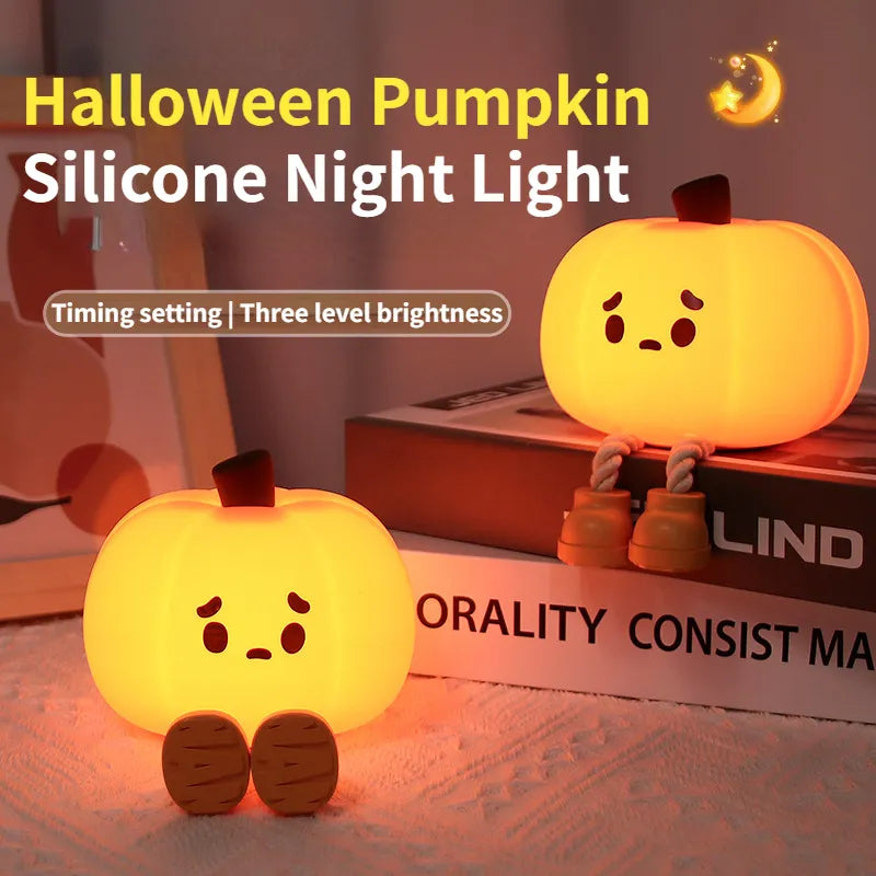 Pumpkin silicone night light glowing warm on a bedside table