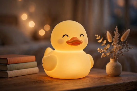 Cute duck night lamp glowing warmly on a bedside table