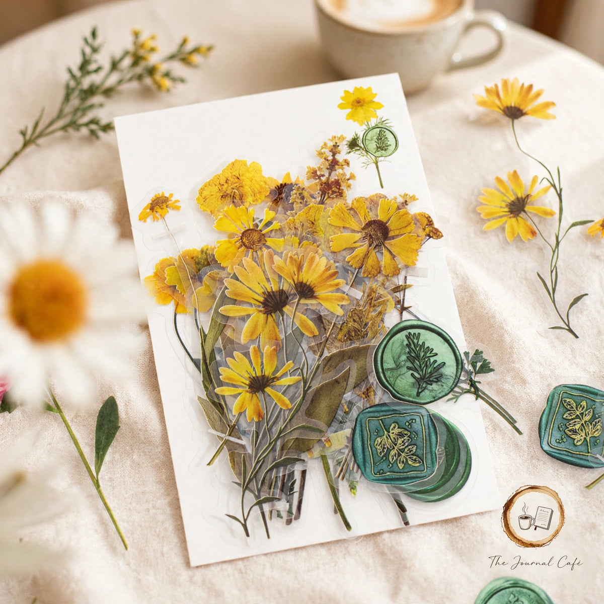 Dried Flowers Sticker Pack — pressed yellow daisy and botanical stickers with green wax-seal designs styled on a cream café table, The Journal Café