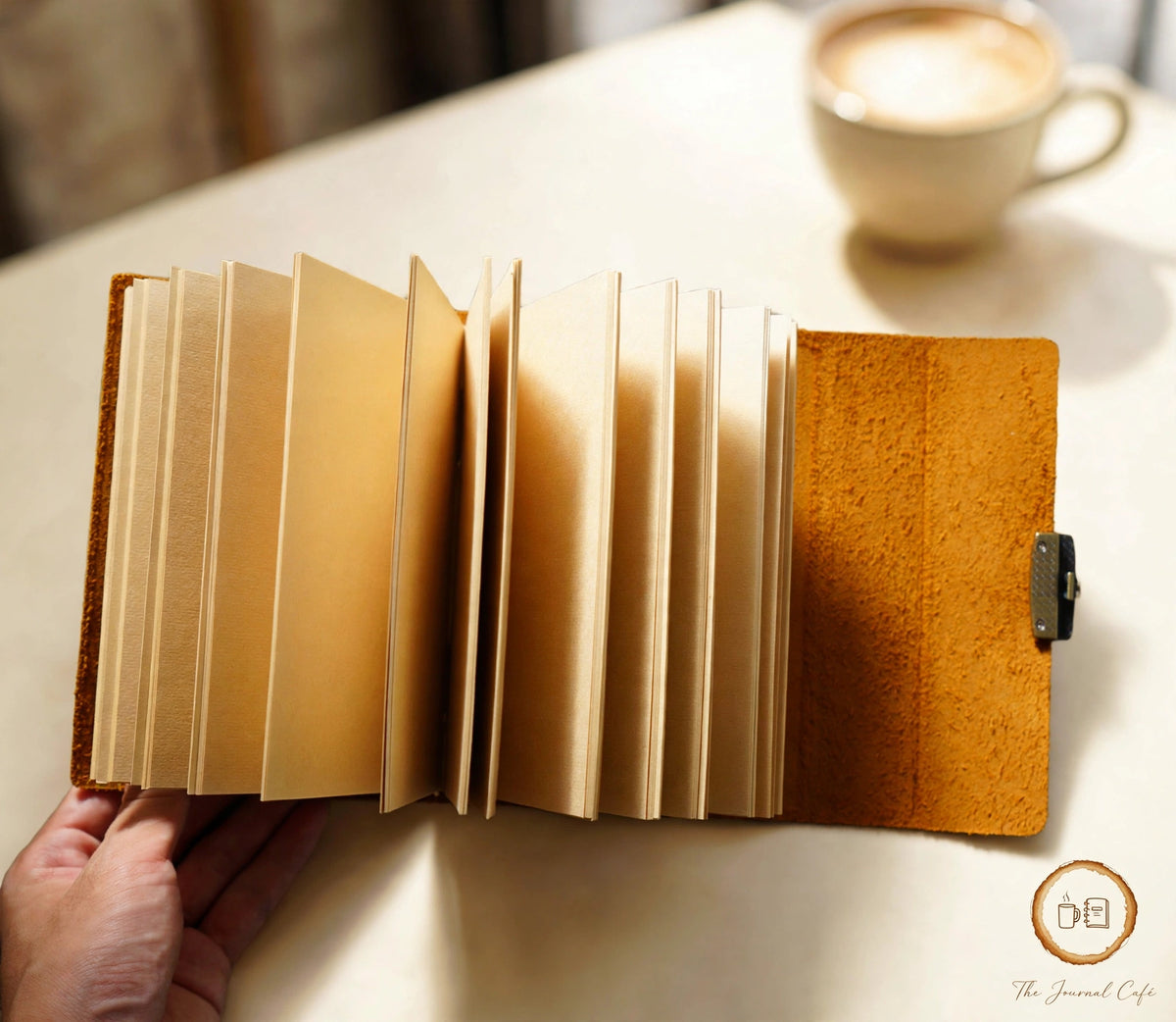 Vintage notebook — product photo 4 styled on a cream café table, The Journal Café
