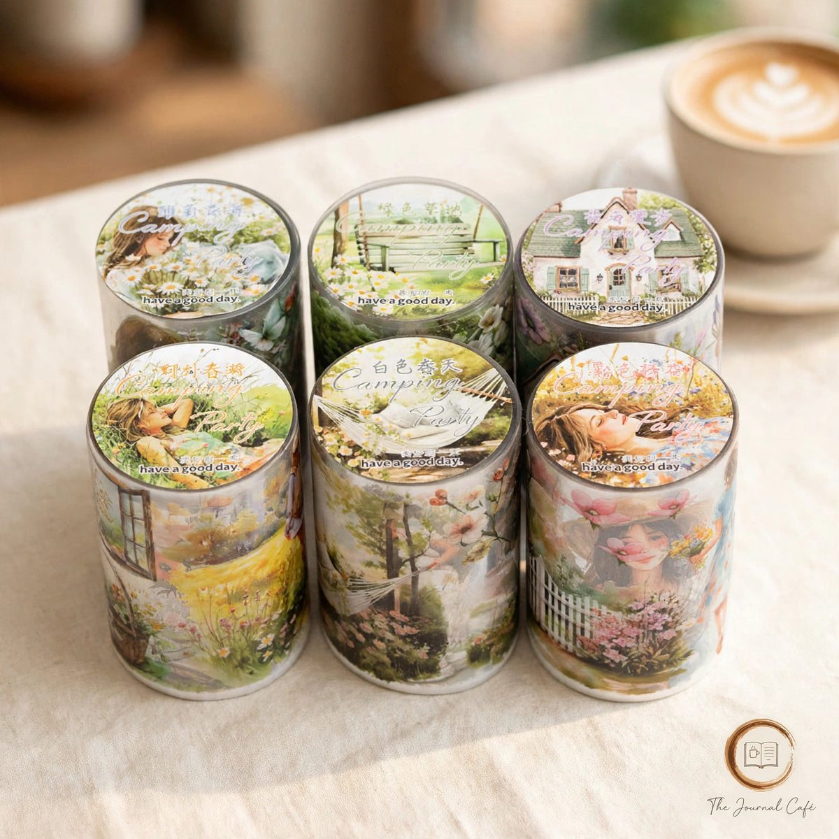 Watercolor camping travel journal tape — product photo 5 styled on a cream café table, The Journal Café