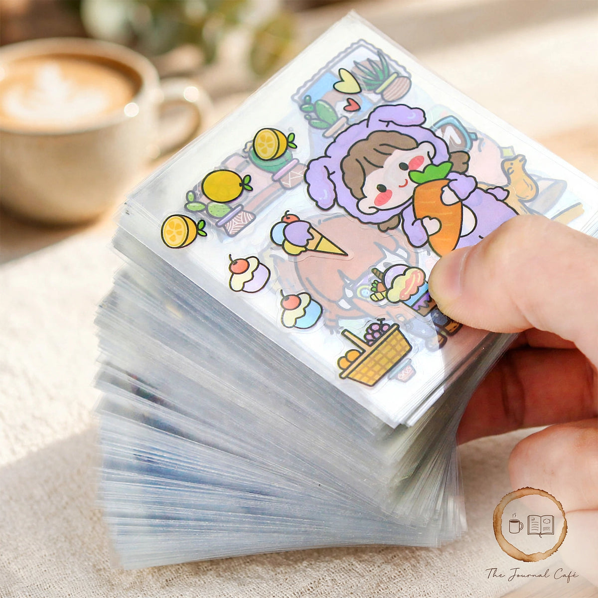 PET journal stickers — product photo 4 styled on a cream café table, The Journal Café