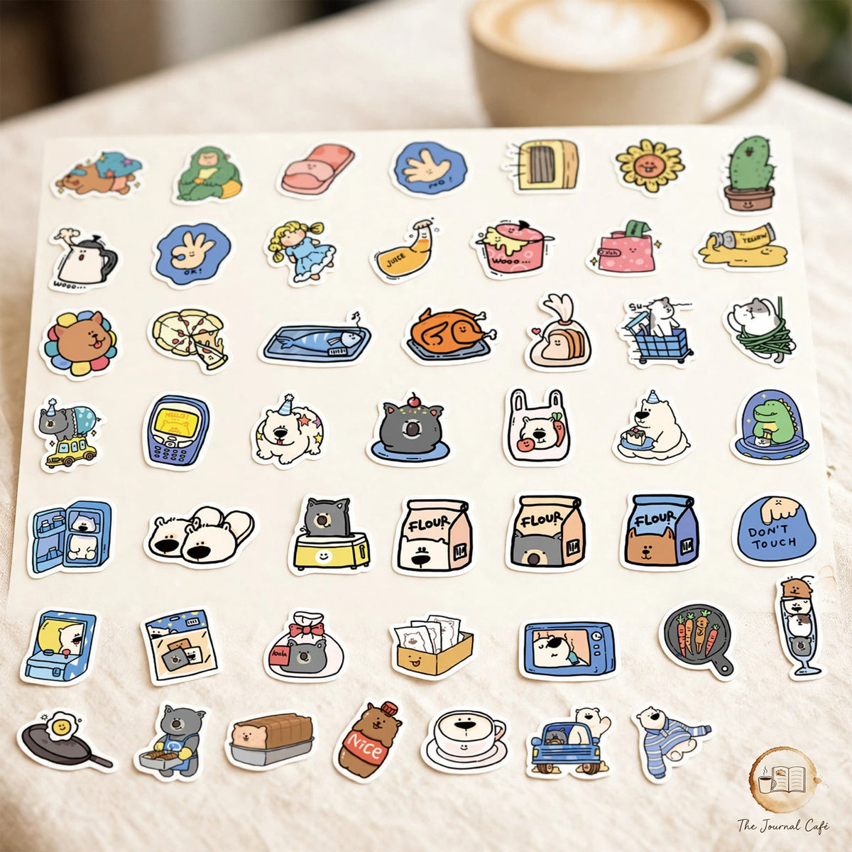 Cartoon animal hotel stickers — product photo 3 styled on a cream café table, The Journal Café