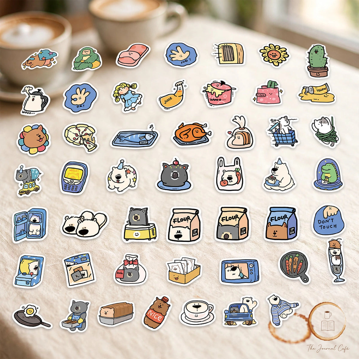 Cartoon animal hotel stickers — product photo 6 styled on a cream café table, The Journal Café