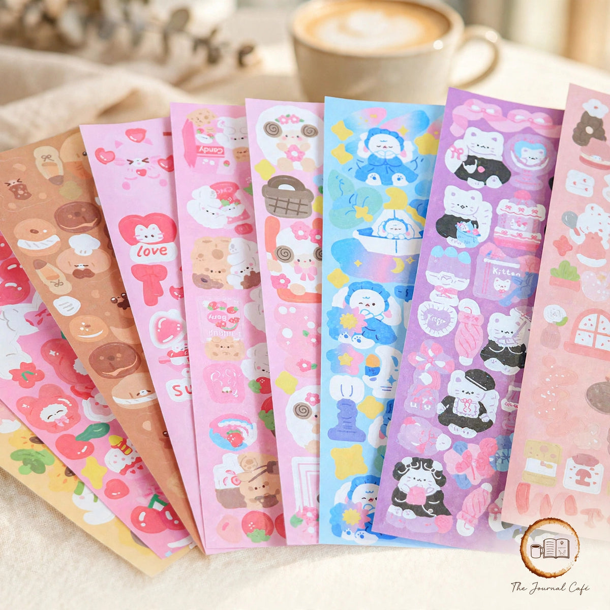Holographic laser sticker sheets — product photo 11 styled on a cream café table, The Journal Café