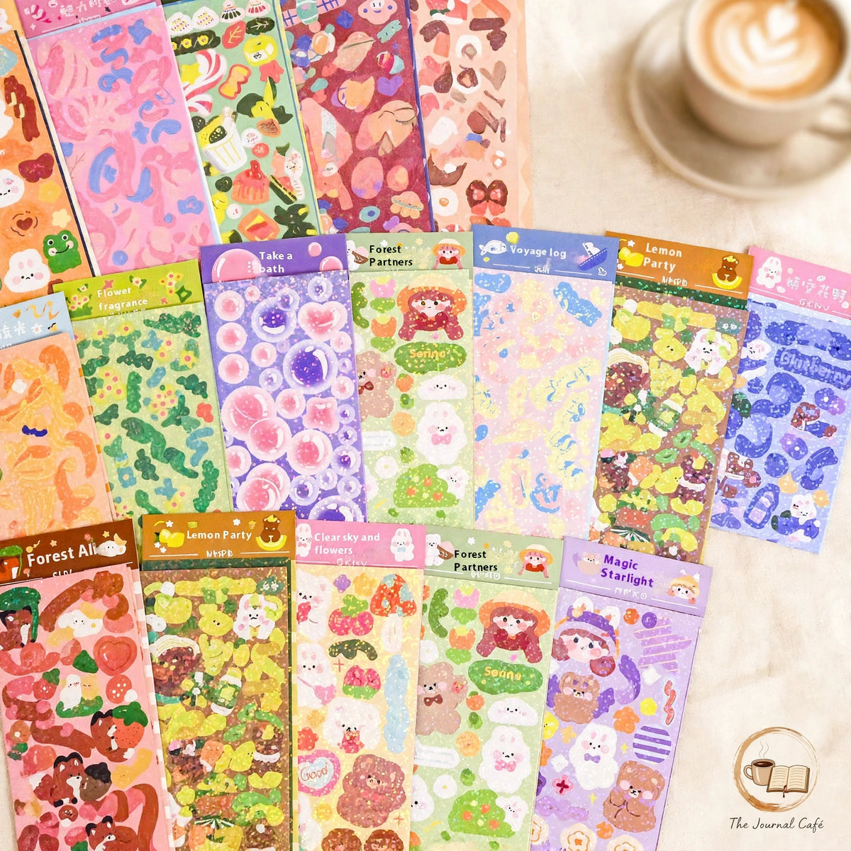 Holographic laser sticker sheets — product photo 4 styled on a cream café table, The Journal Café