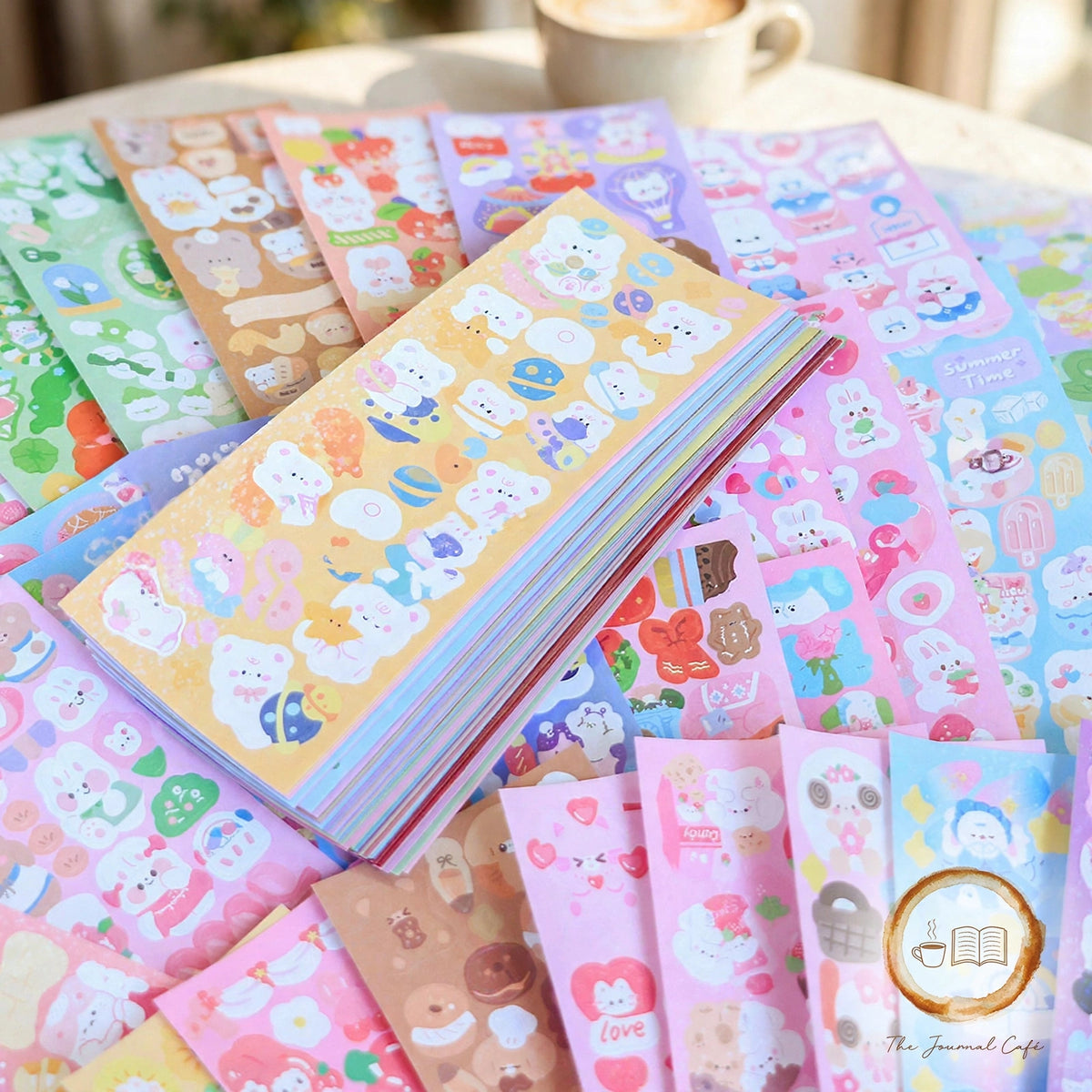 Holographic laser sticker sheets — product photo 10 styled on a cream café table, The Journal Café