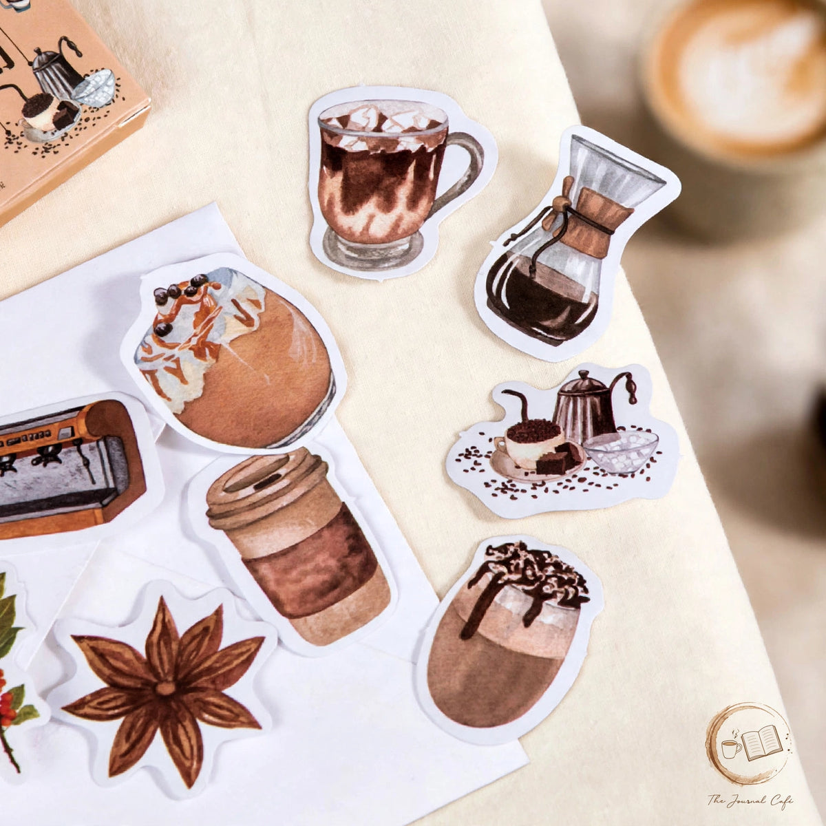 Coffee shop sticker box — product photo 4 styled on a cream café table, The Journal Café