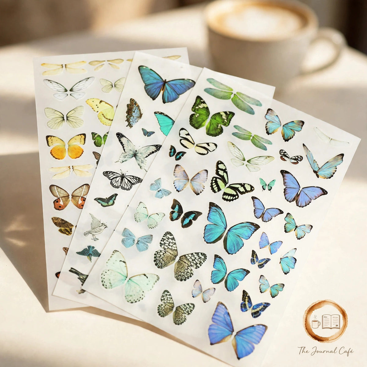 Rub on transfer stickers — product photo 4 styled on a cream café table, The Journal Café