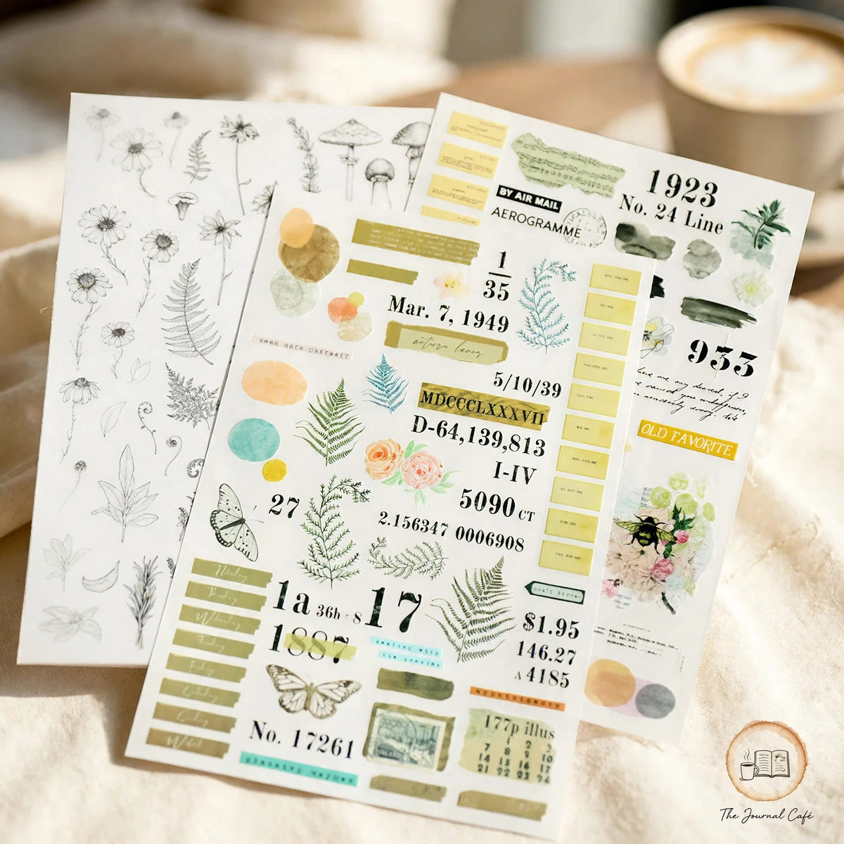 Rub on transfer stickers — product photo 6 styled on a cream café table, The Journal Café