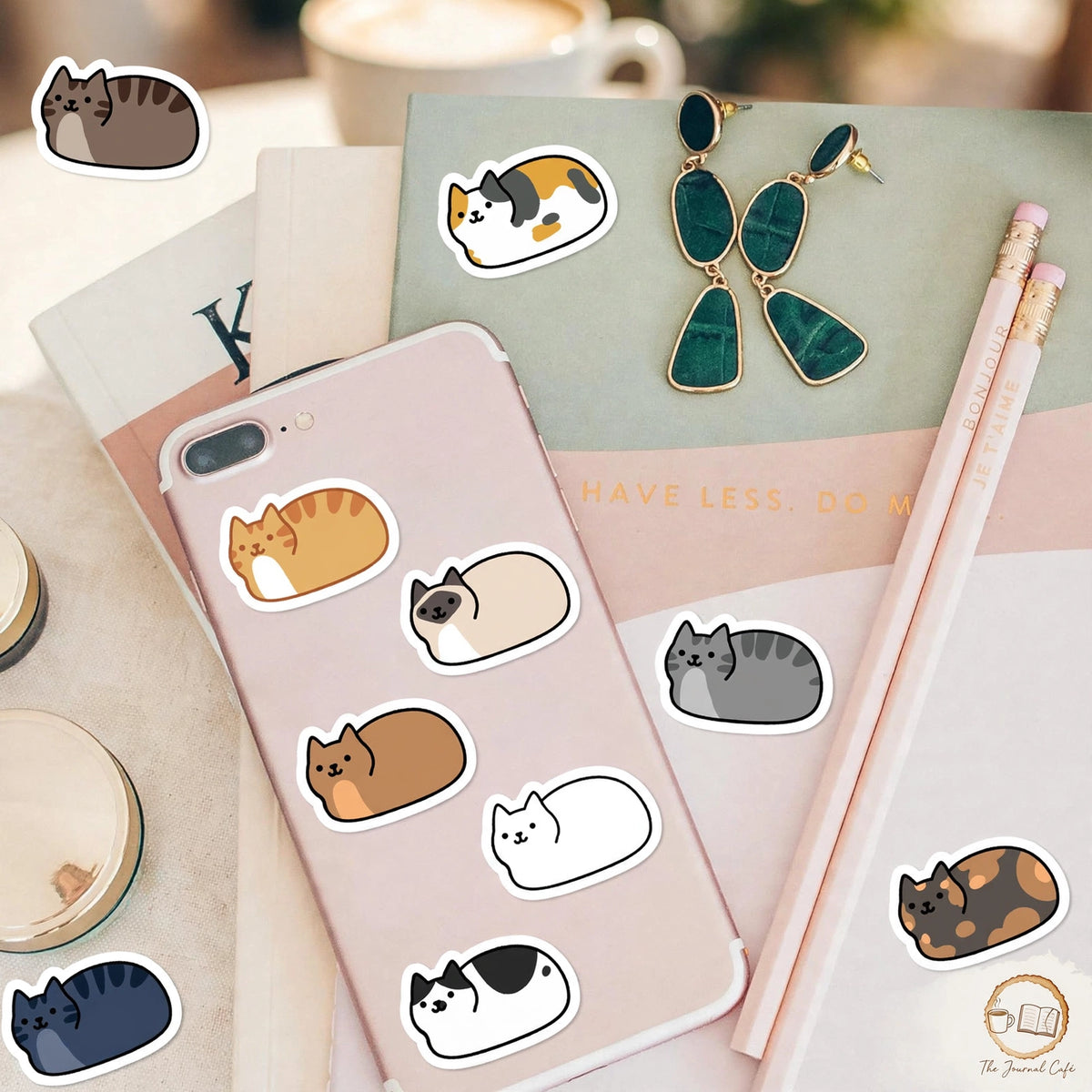Personality cat stickers — product photo 2 styled on a cream café table, The Journal Café