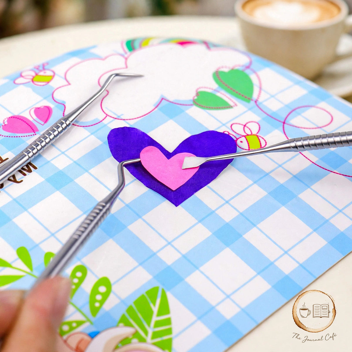5-piece vinyl sticker tool set styled on a cream café table, The Journal Café