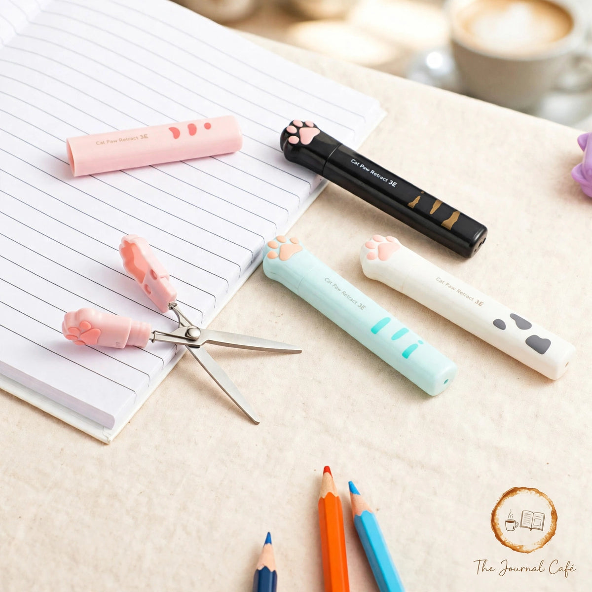 Cat paw mini folding scissors — product photo 10 styled on a cream café table, The Journal Café