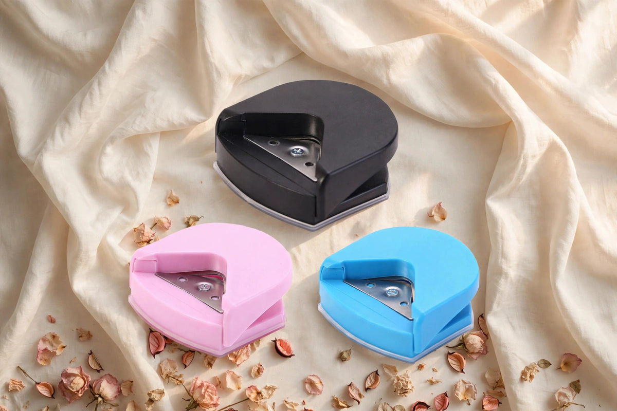 Corner cutter punch in black, pink and blue on ivory silk background