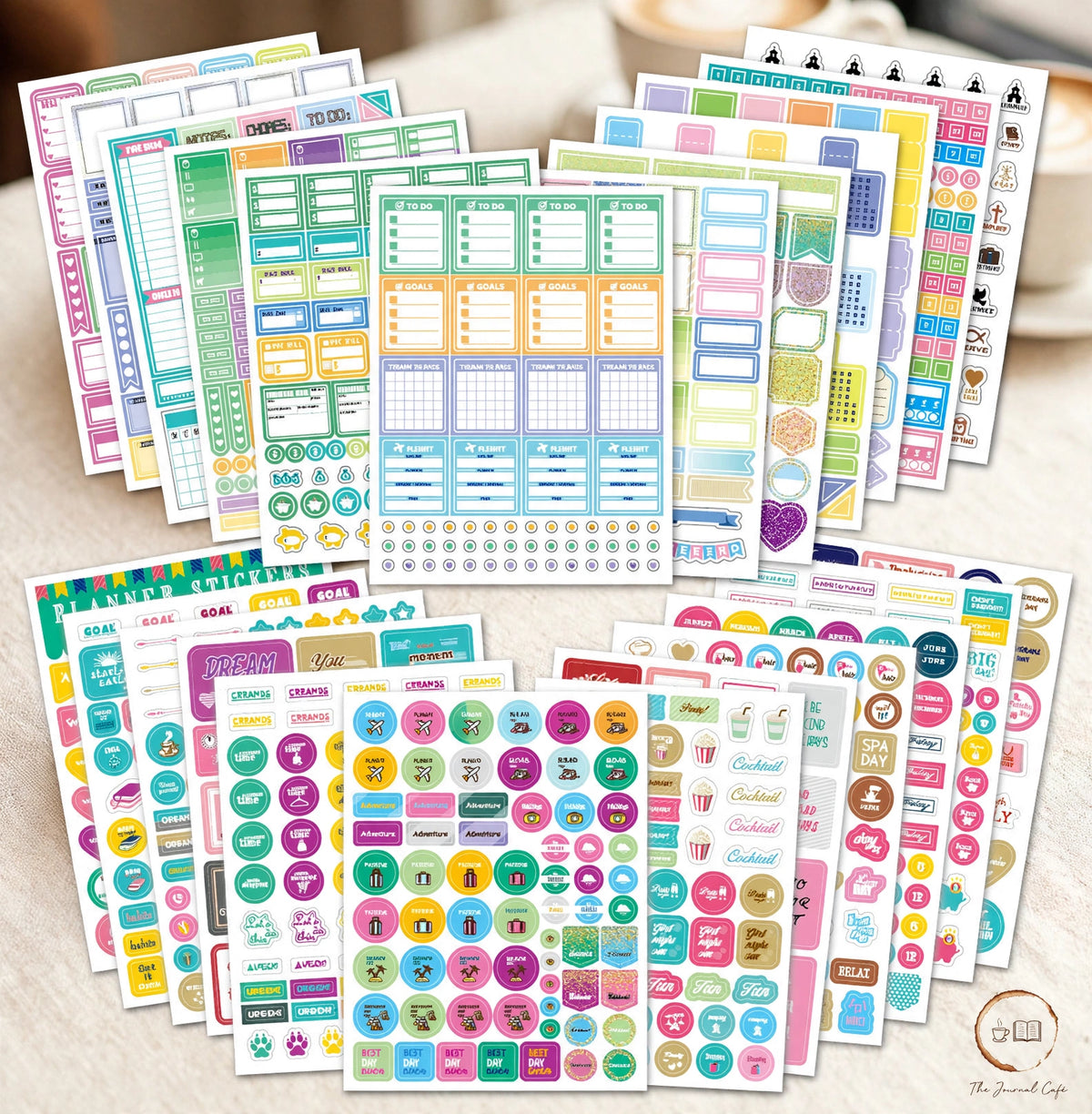 Seasonal monthly planner stickers — colorful 12-sheet sticker pack spread styled on a cream café table, The Journal Café