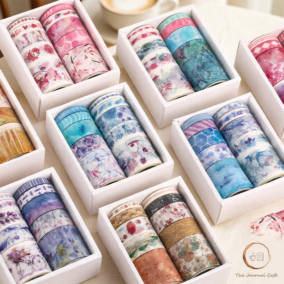 Slim Washi Tape Set — boxed rolls of floral Japanese paper washi tape in mixed widths on a cream café table, The Journal Café