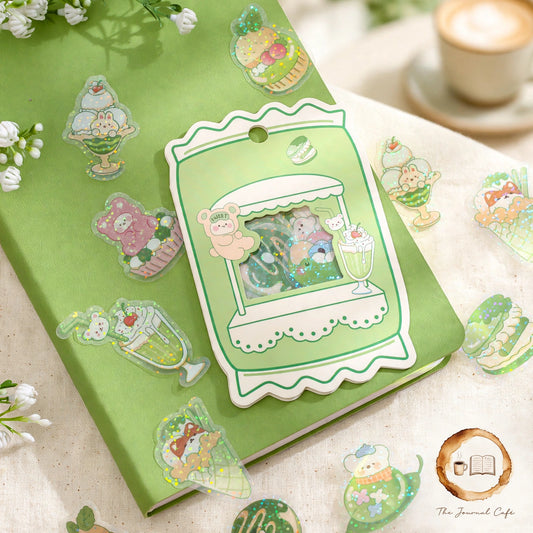 Sweetheart Convenience Store Sticker Pack — cute convenience-store stickers with a sparkly glitter finish styled on a cream café table, The Journal Café